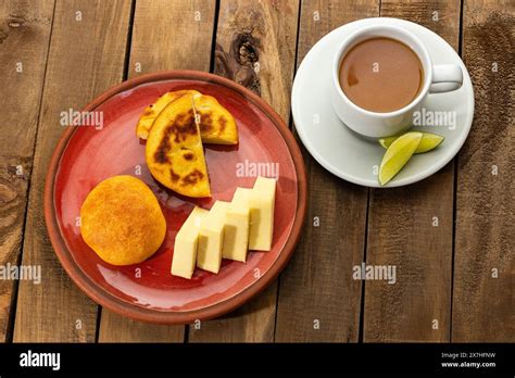 Boyacense breakfast with arepa, cheese, almojabana and aguapanela with ...