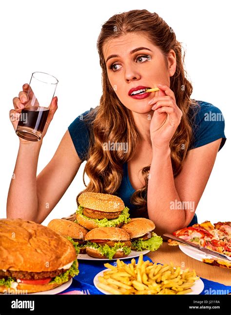 Woman eating french fries and hamburger Stock Photo - Alamy