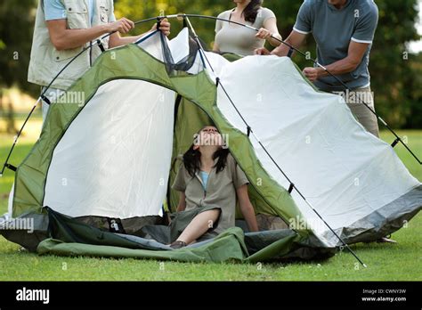 Campers setting up tent Stock Photo - Alamy