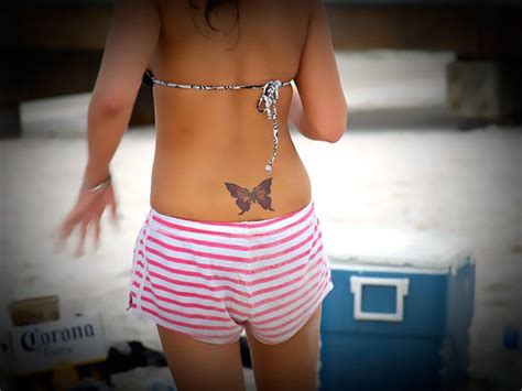 Small Butterfly on Lower Back Tattoo Idea