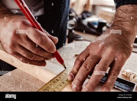 Carpenter makes pencil marks on a wood plank Stock Photo - Alamy