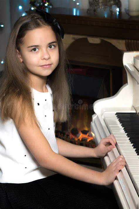 Little Girl Plays the Piano by Candlelight. Stock Photo - Image of ...