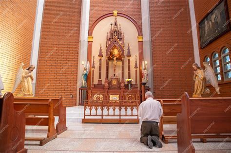 Premium Photo | Man praying on his knees in a church in colombia