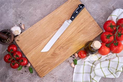 Premium Photo | Wooden cutting board and Steel kitchen bread knife on ...