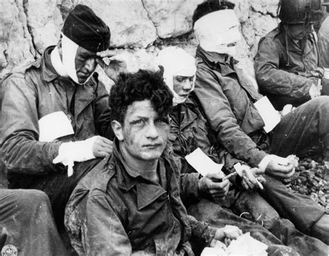 Wounded men of the 3rd Battalion, 16th Infantry Regiment, 1st Infantry Division, receive ...
