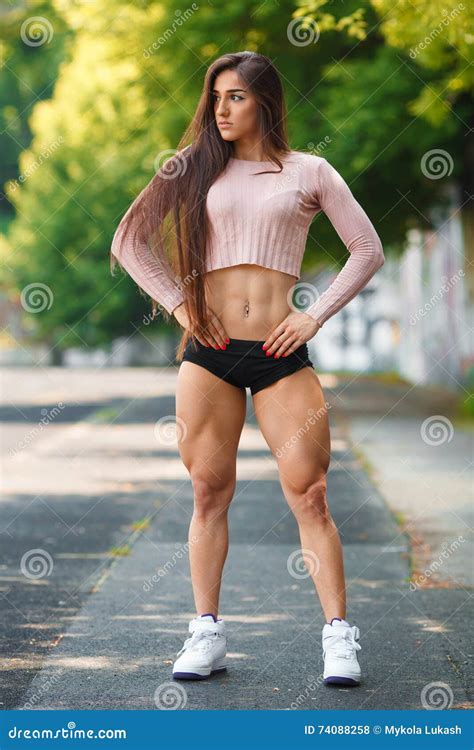 Beautiful Muscular Girl Posing Outdoor. Athletic Woman with Big Quads ...