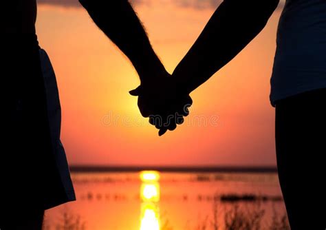 Couple at Sunset Holding Hands Stock Photo - Image of hold, silhouette ...