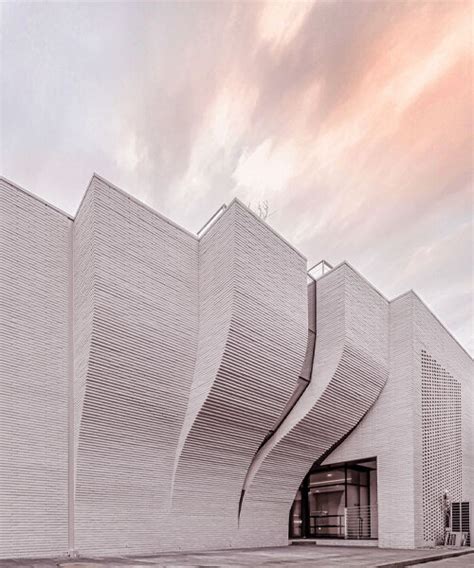 a curved brick wall ripples across LESS architects' office building design in seoul