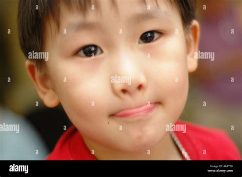 5 year old Chinese Asian boy wearing a red t-shirt Stock Photo - Alamy