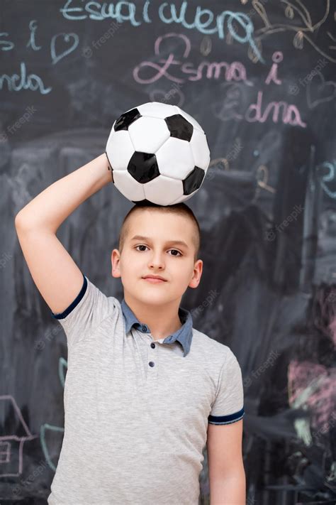 Premium Photo | Portrait of happy cute boy having fun holding a soccer ...