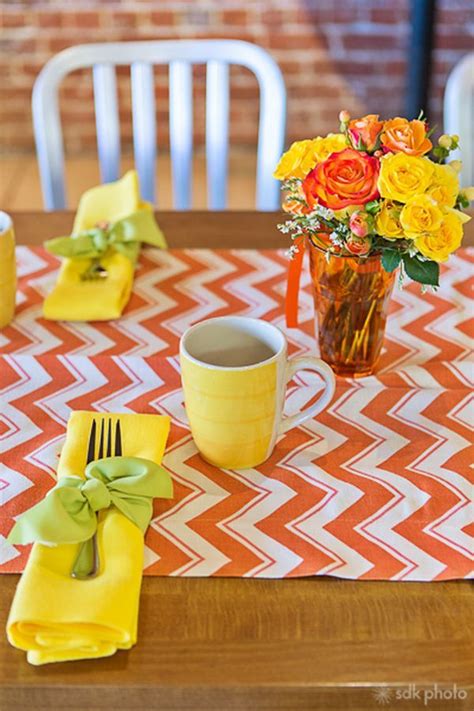 the table is set with yellow napkins and flowers