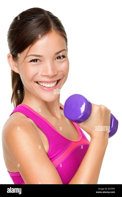 Portrait of happy mixed Caucasian Asian fit woman lifting dumbbells isolated on white background ...