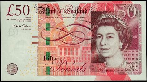 the british 50 pound notes are stacked on top of each other