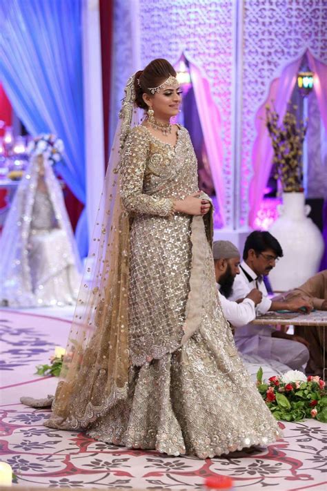 a woman in a wedding dress on the runway