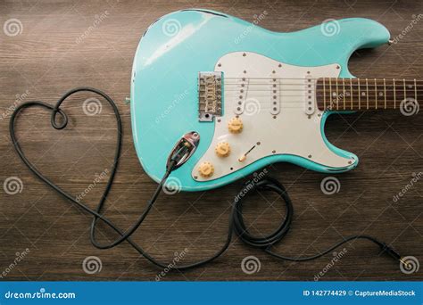 Music Love Concept. Wire Jack Heart Guitar. Light Blue Electric Guitar In A Wood Texture Stock ...