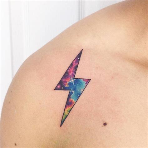 Galactic lightning bolt tattoo on the right shoulder.