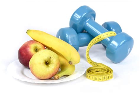 Fitness and Weight Loss Concept. Apples, Dumbbells,Tape Measure, Bananas