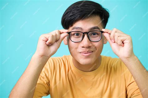 Premium Photo | Smiling young man wearing glasses look at camera over ...