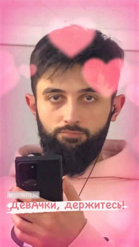 a man taking a selfie in front of a mirror with hearts on his head