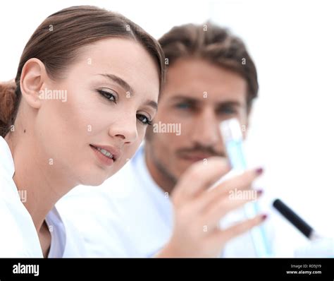 Woman looking at test tubes with colorful liquids Stock Photo - Alamy