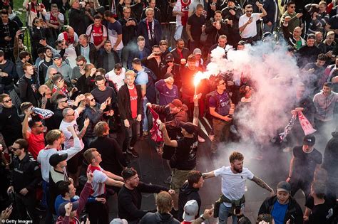 Shirtless Ajax fan climbs scaffolding to lead chants in central London ...