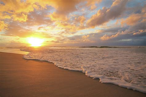 Beach sunset with golden clouds Photograph by Keiran Lusk - Fine Art ...