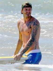 Beach body: 38-year-old David Beckham showed off his muscular physique ...