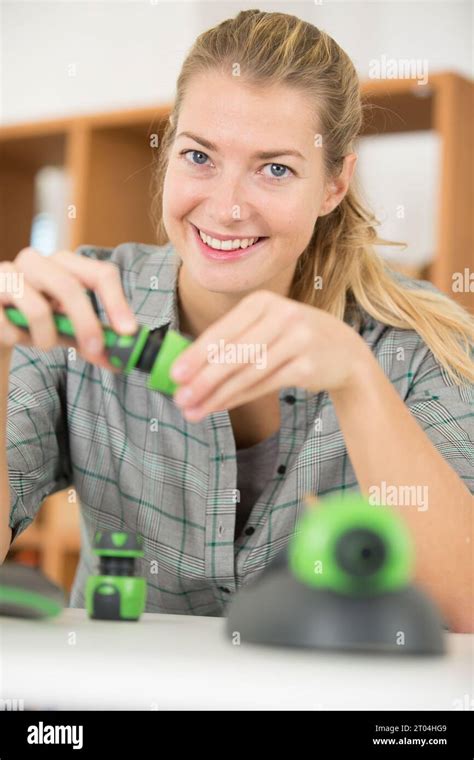 young lady assembling new hose fittings Stock Photo - Alamy