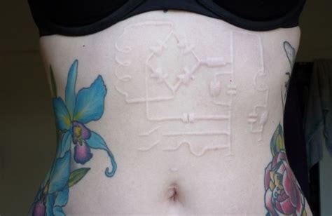 Pretty Scarification Tattoo Designs for Women - TattoosEra