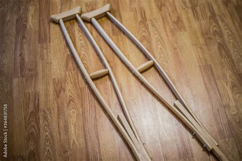 Wooden crutches on a wooden floor, for the movement of people with disabilities, people with ...