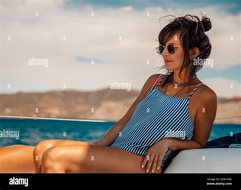 Nice Girl Tanning on the Sailboat. Luxury Summer Trip to Greece. Recreation on Water Transport ...