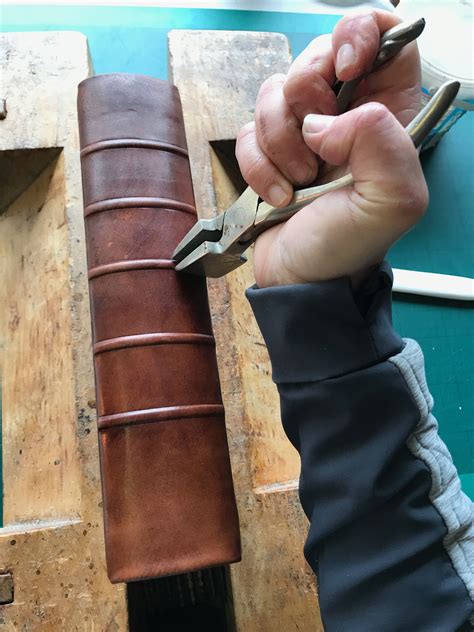 Sharpening the raised bands on a new calf leather binding using band ...