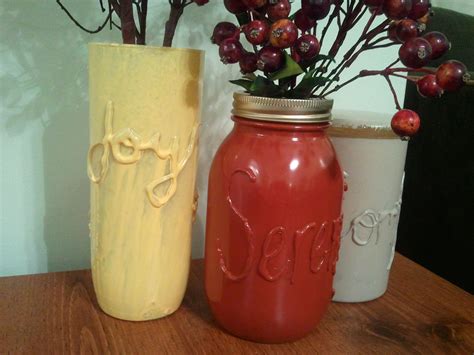 Hot glue words on glass jars, then spray paint