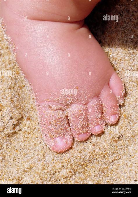 Baby foot in the sand Stock Photo - Alamy