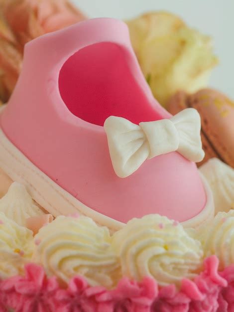 Premium AI Image | Pink Baby Shoes Cake Topper with Boy or Girl Sign for Baby Shower Gender Reveal