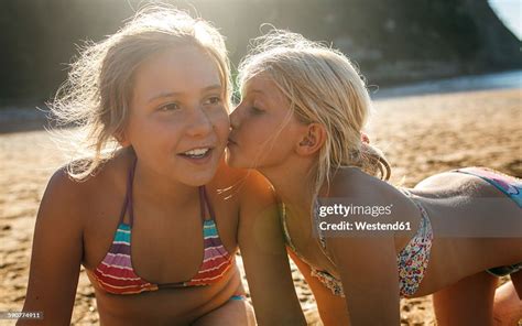 Two Sisters Having Fun Together On The Beach High-Res Stock Photo ...