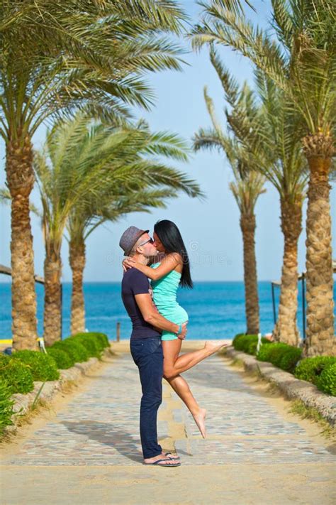 Couple Kissing In Romantic Embrace On Beach Stock Image - Image of embracing, black: 12442641