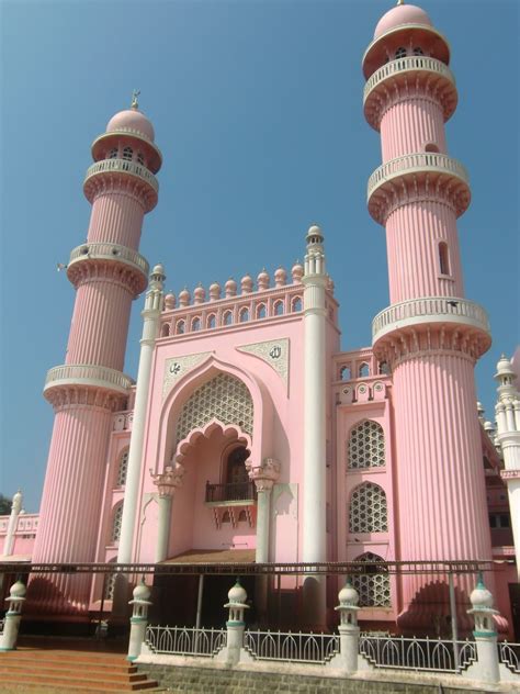 pink and white building with two towers on each side