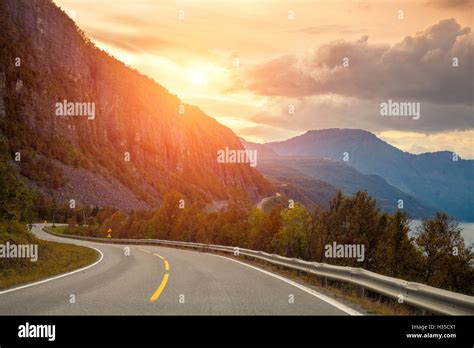 Mountain road at sunset Stock Photo - Alamy