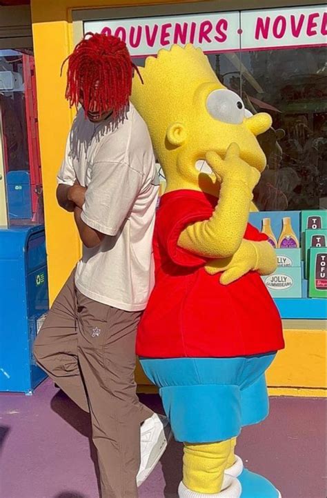 a man standing next to a large cartoon character