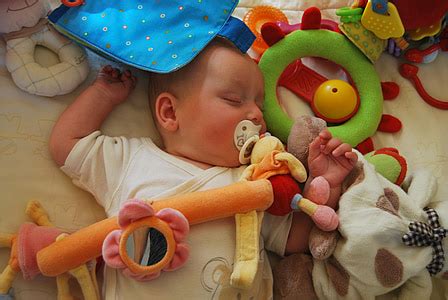 Royalty-Free photo: Baby sleeping while surrounded by toys | PickPik