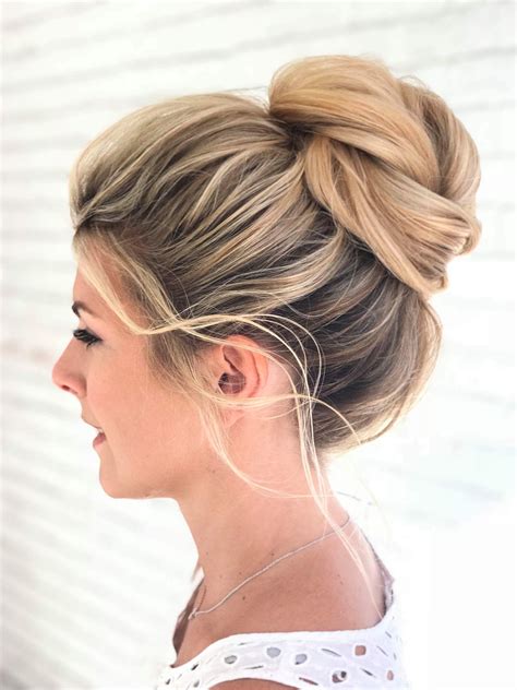 Messy high bun on blonde highlighted hair, gorgeous for a wedding updo | Messy hairstyles, High ...