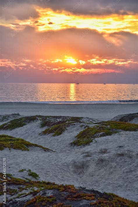 Coronado Beach in San Diego by the Historic Hotel del Coronado, at sunset with unique beach sand ...