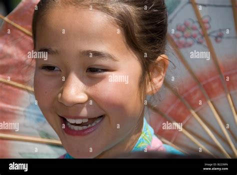 Japanese girl with umbrella at the Cherry Blossom Festival Grand Parade, San Francisco ...