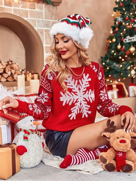 a woman sitting on the floor next to christmas presents wearing a red ...