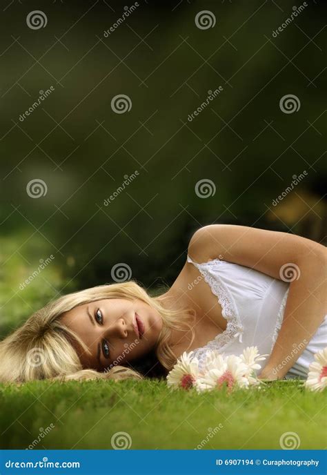 Young Model Laying Down in Grass Stock Photo - Image of body, closeup ...