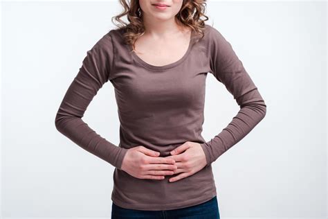 Young girl with abdominal pain close up, stomach pain clutching her ...