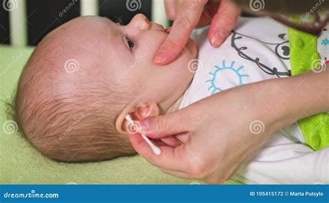 Mother is Cleaning Her Baby Ears Stock Photo - Image of newborn, funny: 105415172