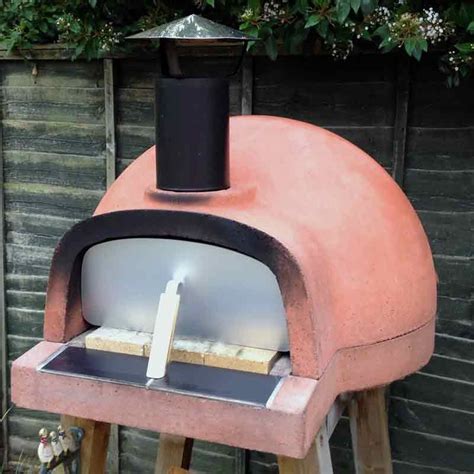 an outdoor pizza oven with the lid open