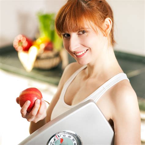 Premium Photo | Loosing weight - woman with scale and apple